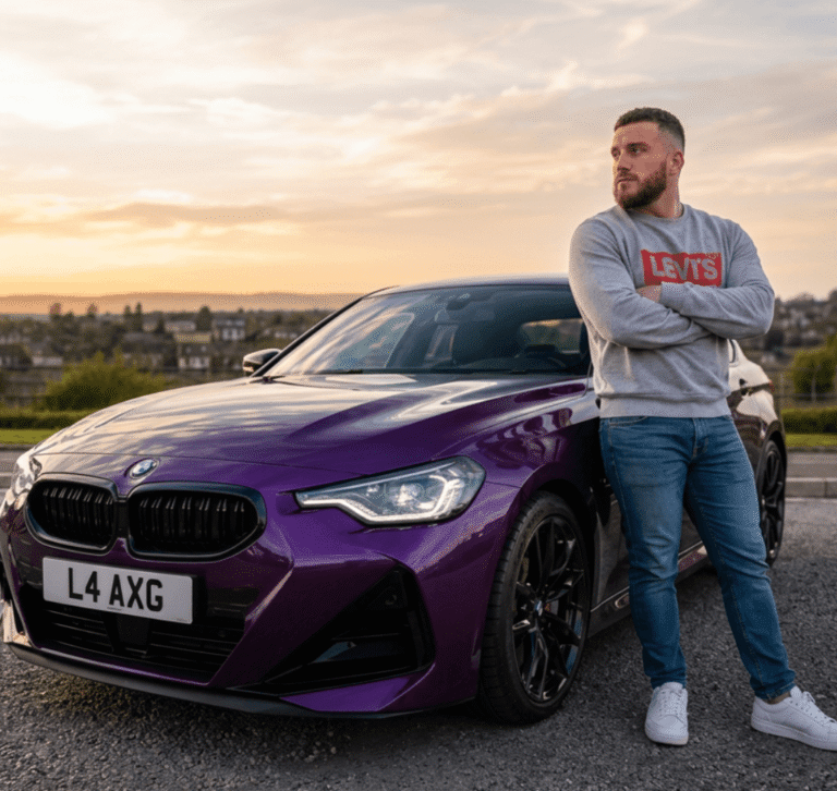 Tom Langlands beside a car