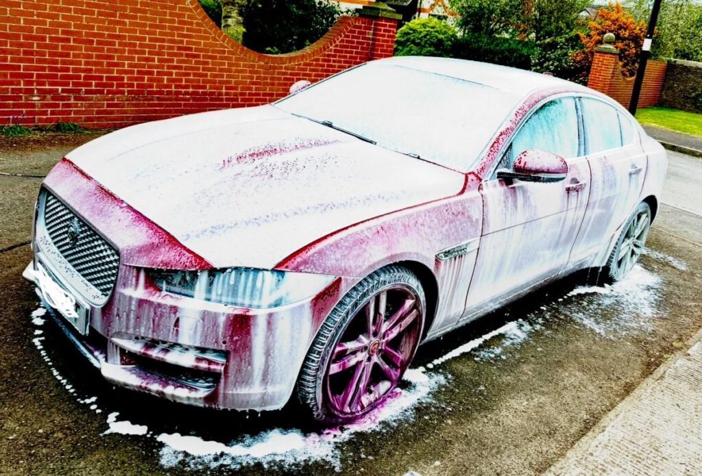 Car being washed during exterior cleaning